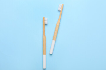 Wooden toothbrushes on blue background