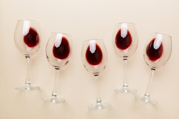 Many glasses of red wine at wine tasting. Concept of red wine on colored background. Top view, flat lay design