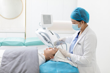 Young woman receiving face treatment in hospital