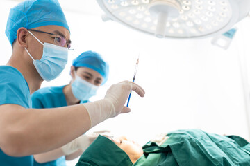 Mid adult woman receiving facial plastic surgery