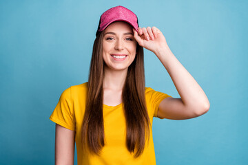 Naklejka premium Photo of pretty confident lady look camera shiny smile wear pink cap yellow t-shirt isolated blue color background