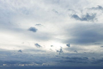 the sky with gray cirrus clouds at sunset shines with a leaden gleam behind the clouds. nature clouds