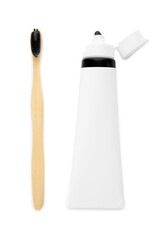 Tube with black tooth paste and brush on white background