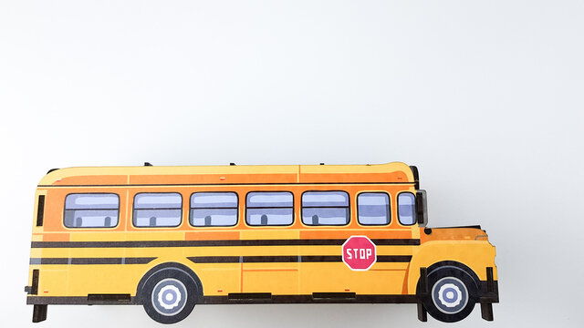 an image of a yellow school bus on a white background. study