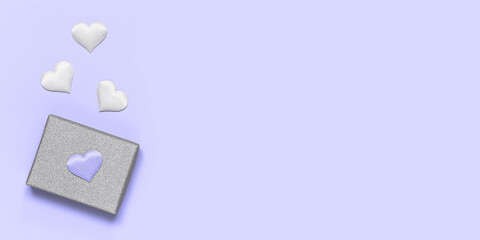 Silver gift box with decorative hearts on a violet background. Gift for Valentine's Day. Banner. Very peri, color of the year 2022.