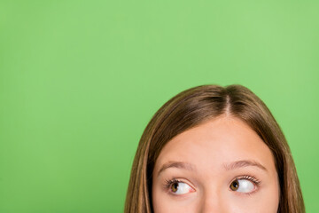 Cropped photo of young lady look empty space preposition wonder advert isolated over green color...