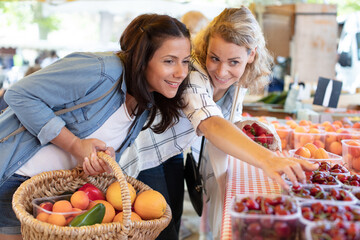 two women buying fruits in the market