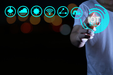 Man in white shirt is controlling home appliances with iot technology in smart house concept.