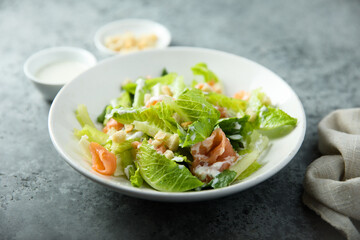 Traditional homemade Caesar salad with smoked salmon