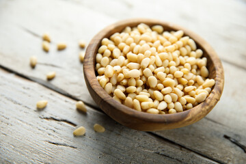Organic pine nuts in a wooden bowl	
