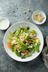 Traditional homemade Caesar salad with smoked salmon