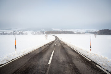 Fototapeta premium Country road in snowy winter day