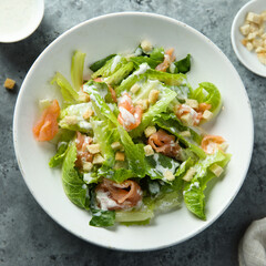 Traditional homemade Caesar salad with smoked salmon