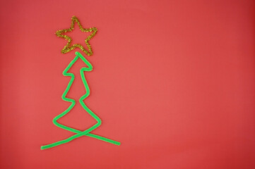 Christmas background with golden Christmas pentagram. Green plush thread in the shape of a...