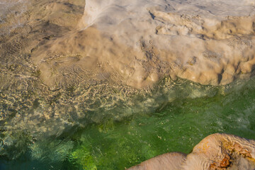 PAMUKKALE, TURKEY: A stream of natural water on white travertines.