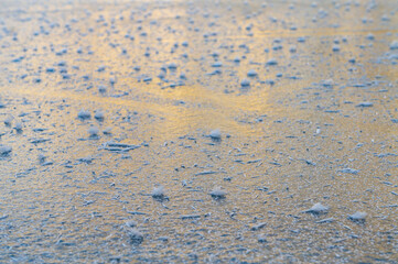 Ice texture frozen lake surface on sunny day
