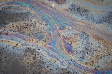 Beautiful abstract stain of motor oil, gas or petrol spilled on the asphalt
