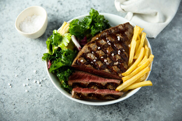 Beef steak with French fries and salad