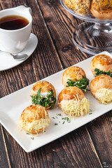 Turkish pastry filled with dill, parsley, cream cheese and cheddar cheese. Turkish name: Sakallı Pogaca or Saçaklı Pogaca