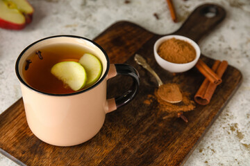 Obraz na płótnie Canvas Cup of tasty fruit tea with cinnamon on light background