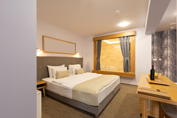 Interior of a luxury hotel double bed bedroom with glass bathroom wall