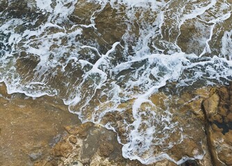 sea water with foam on the rocky coast