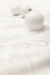 Christmas white background with christmas ball and light glare