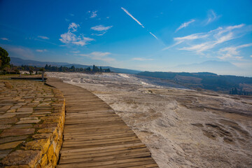 PAMUKKALE, TURKEY: Beautiful landscape with panoramic views of the white travertine and the mountains.