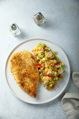Homemade chicken schnitzel with rice and vegetables