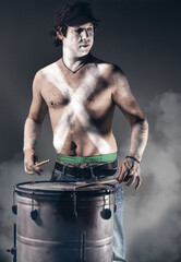 Musician drumming solo with painted body