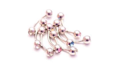 A set of jewelry for piercing on a white background. A set of earrings for the body, nose, navel, tongue, nipples, ears, various beauty jewelry, a set of cosmetological jewelry for piercing.