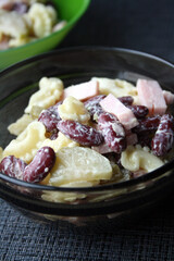Salad of pasta, ham, beans and pickled cucumbers. Belgian cuisine.