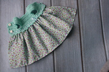 Crochet dress for a doll made of cotton yarn . Home needlework made of thread.