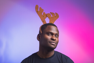 Portrait of african american man wears rudolph deer horns enjoy his accessory for christmas eve...