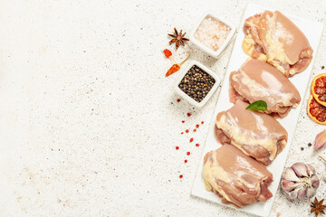 Raw chicken thigh without bones or skin. A useful ingredient for preparing healthy food, spices