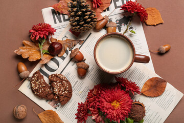 Composition with cup of coffee, newspapers, flowers and natural forest decor on color background