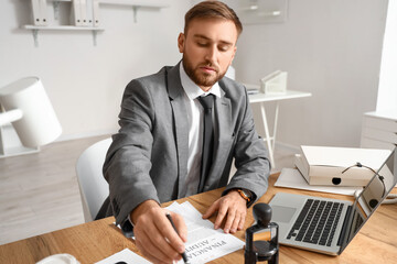 Male notary public working in office