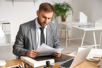 Male notary public working in office