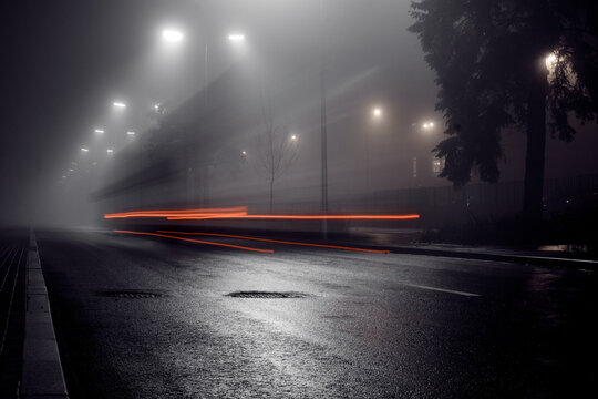 The Car Is Moving On A Foggy Wet Road At Night.