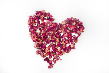 Obraz na płótnie Canvas beautiful heart of dried red rose petals isolated on white background, copy space, Valentines Day romantic concept