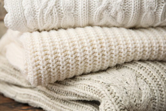 Closeup view of stylish knitted sweaters