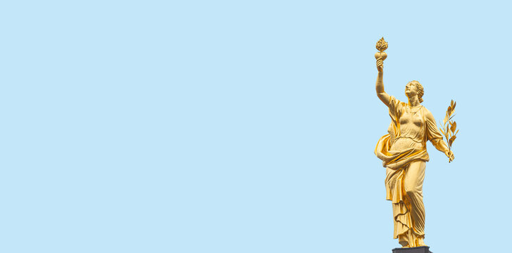Banner with a golden statue of Greek goddess of peace Eirene, Pax, with heart and laurel branch in her hands, symbols of love and peace, at blue sky solid background with copy space.