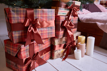 Gift boxes in brown checkered paper, decorated with ribbons and bows. Christmas and New Year concept