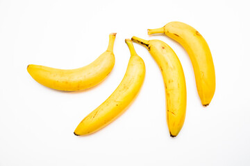 Bunch of yellow bananas laid on white background.