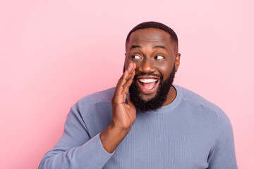 Photo of cheerful guy hand open mouth look side empty space wear grey shirt isolated pink color background