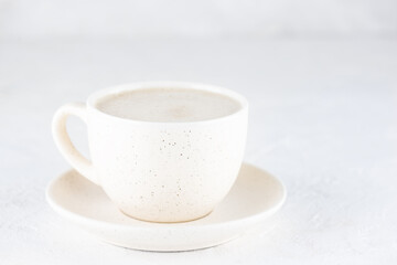 Latte macchiato with lavender in a mug on a light background. Horizontal orientation, copy space. Selective focus.