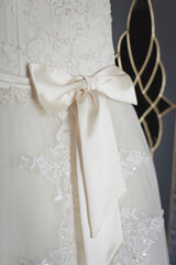 Fototapeta na wymiar Closeup details of Bride's wedding dress, bow