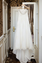 Fototapeta na wymiar Wedding dress in a room. Bride's morning preparation