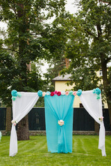 Wedding set up in a garden. Wedding ceremony, Wedding decorations, Archway with aqua and pink colors. Simple wedding. Big day for a couple. Small venue