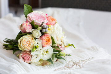delicate wedding bouquet on background of wedding dress